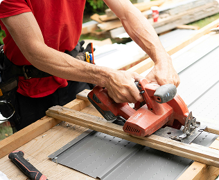 Worker cutting lumber on a construction site